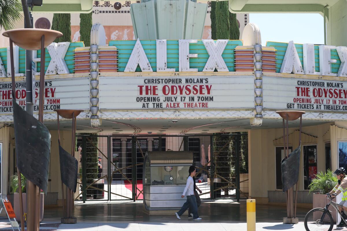 People pass by the historic Art Deco Alex Theatre.