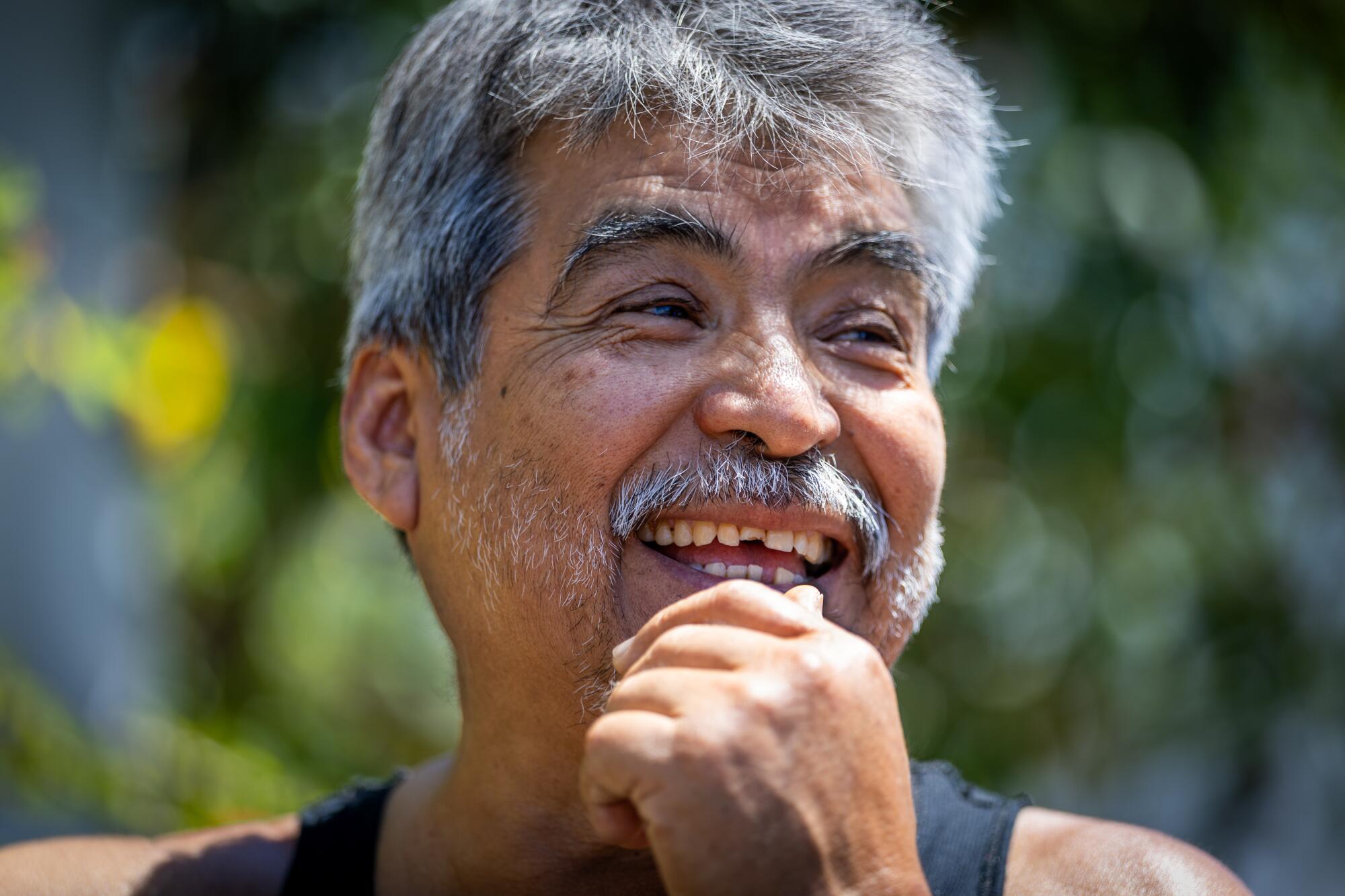 a resident takes a break to talk to visitors