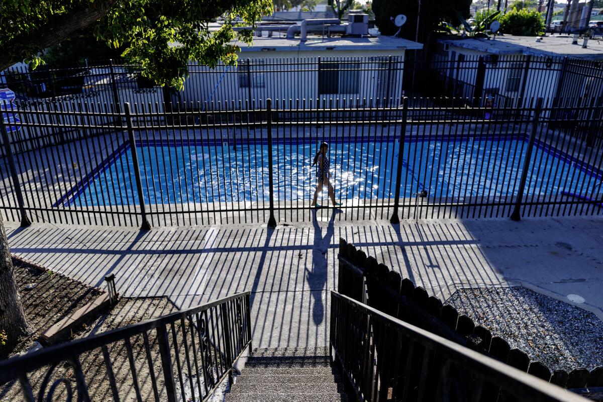 A youngster walks inside the gated pool