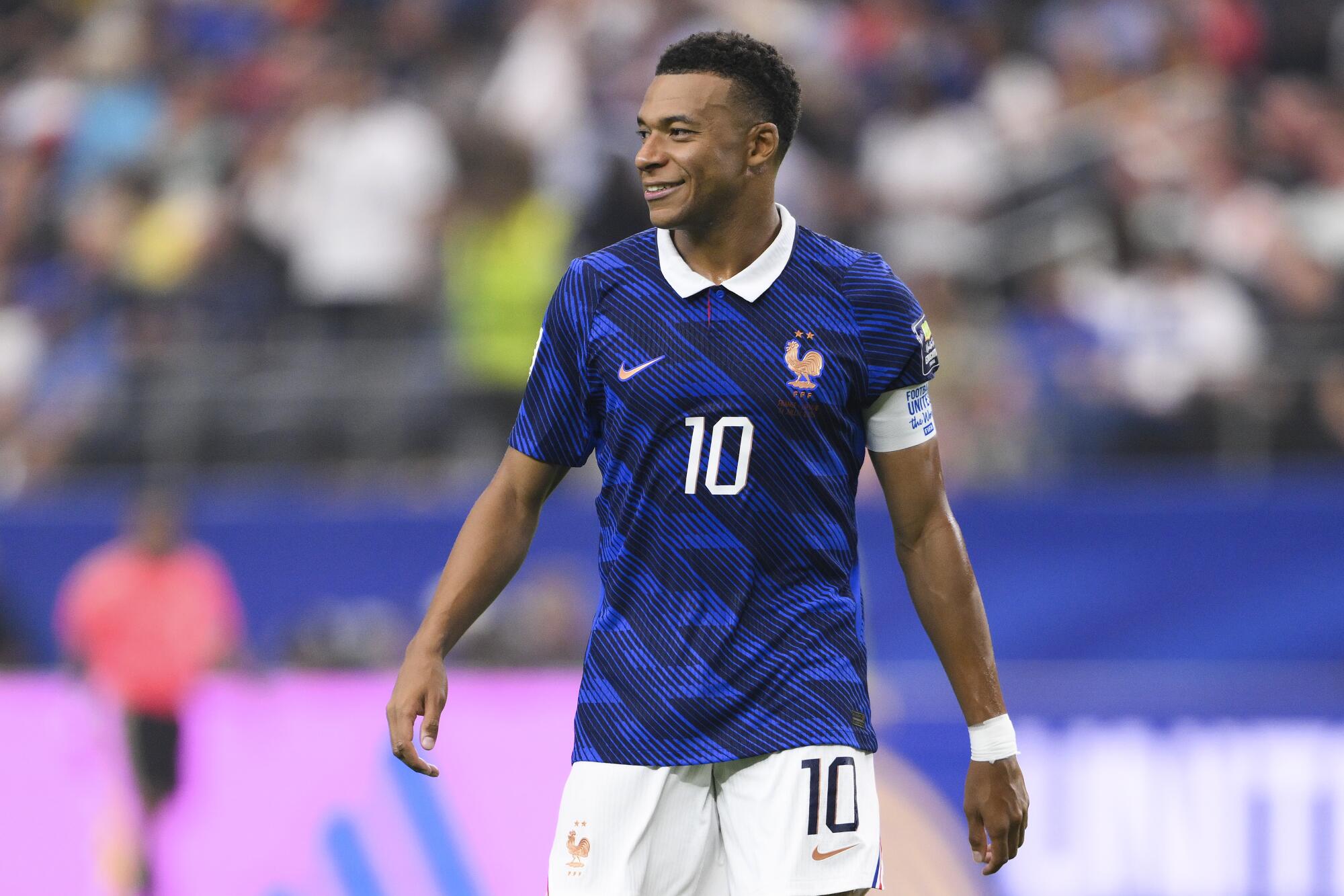 France star Kylian Mbappé smiles during a World Cup semifinal match against Spain on Tuesday.