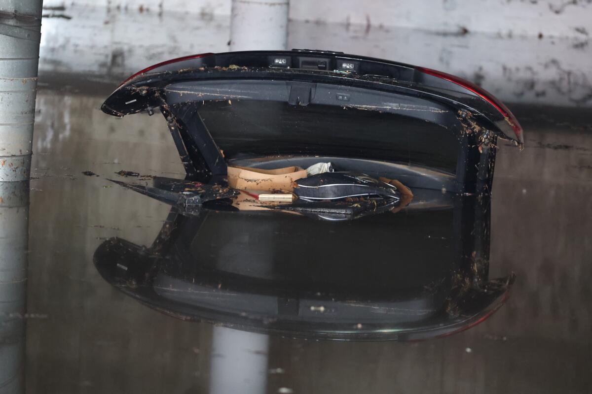  The trunk of a flooded car is seen in an underground garage along Palm Ave. in West Hollywood 