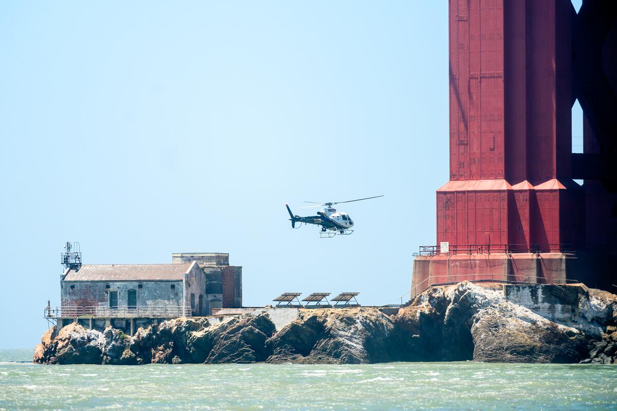 A California Highway Patrol helicopter flies near the Golden Gate Bridge as search and rescue operations continue.