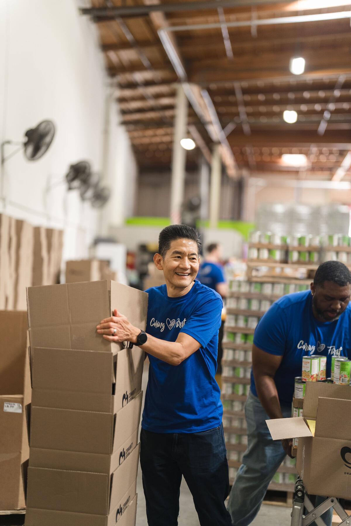 Jon Shigematsu, American First Credit Union chief executive officer, volunteers at the OC Food Bank.