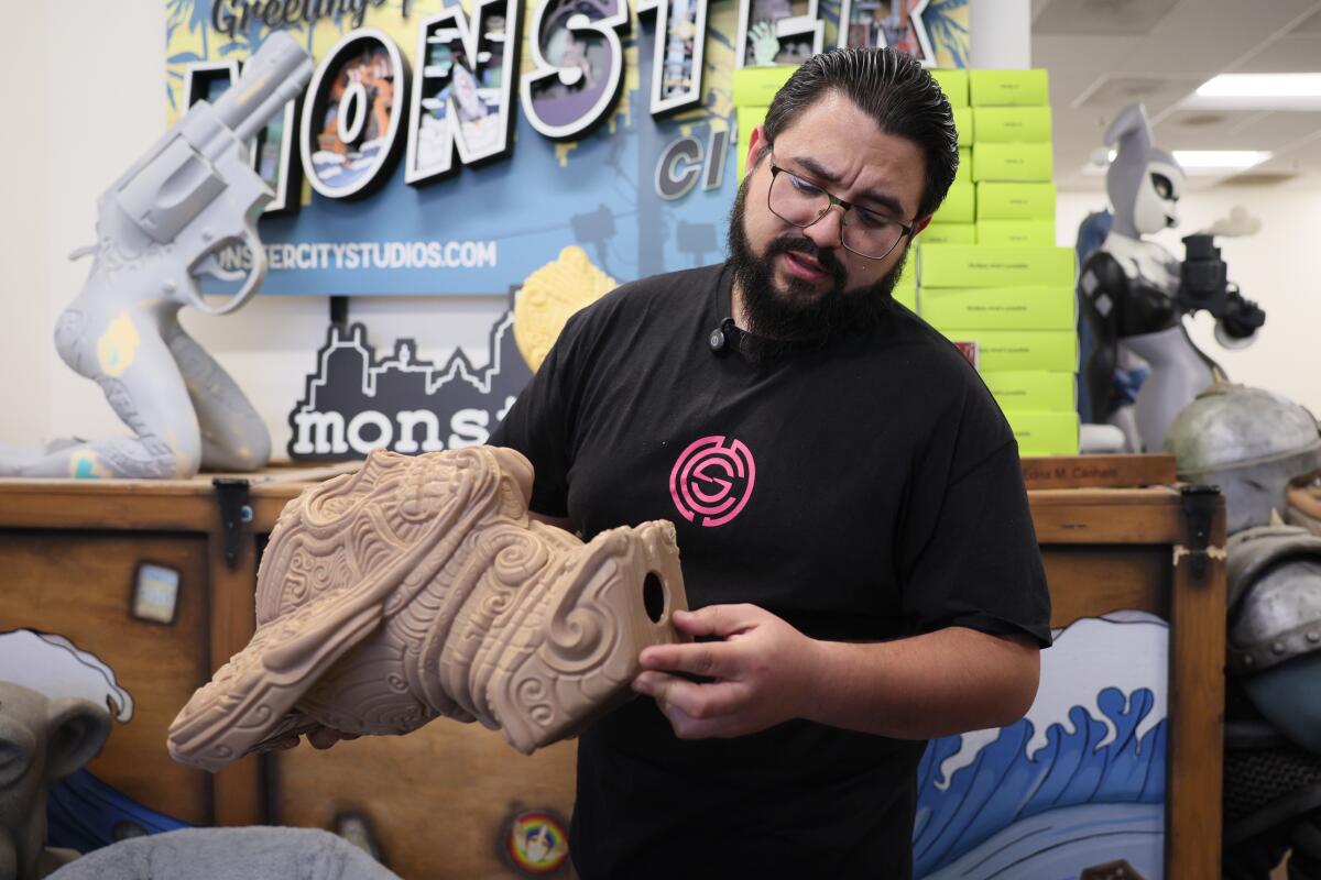 A man holds a 3-D printed head sculpture