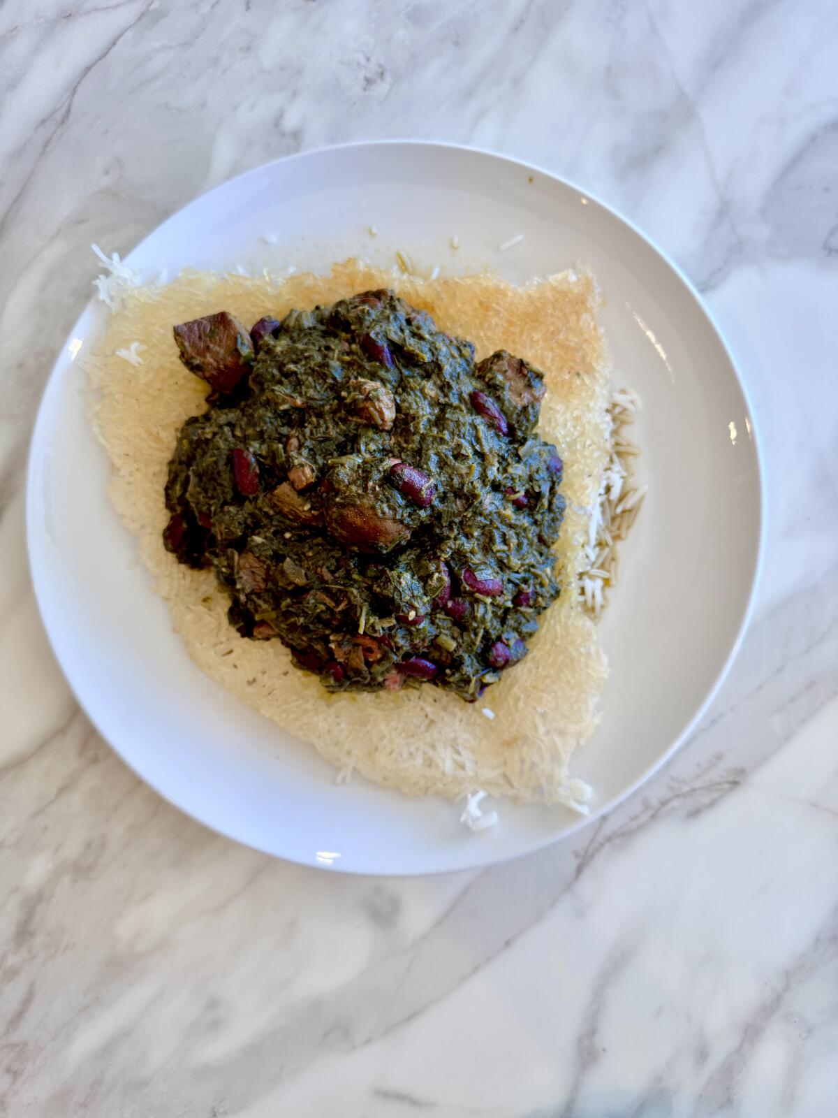 An order of tahdig with ghormeh sabzi at Adana in Glendale.
