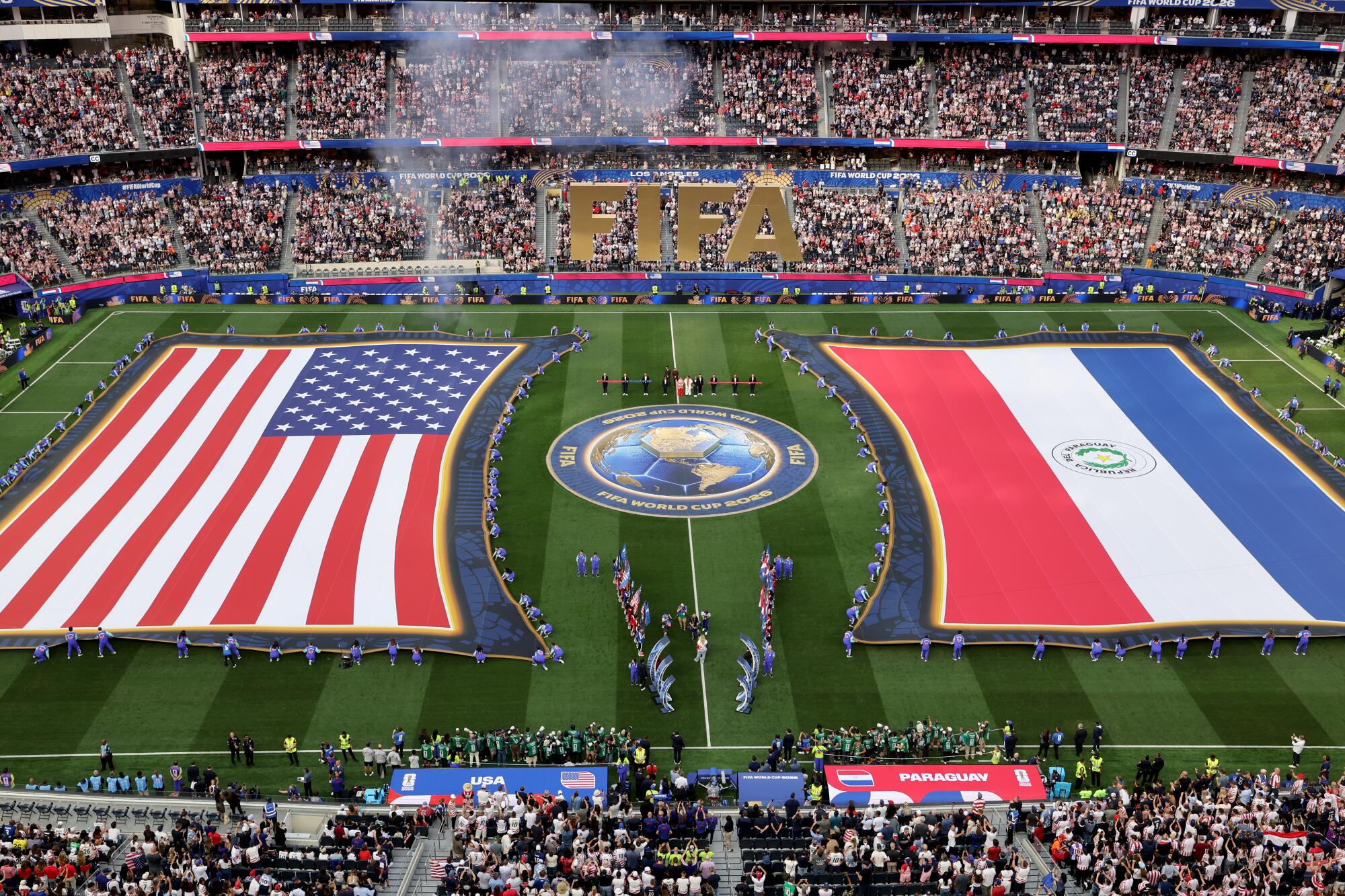 U.S. and Paraguay oversized flags are featured on the pitch before a World Cup match at SoFi Stadium on June 12.