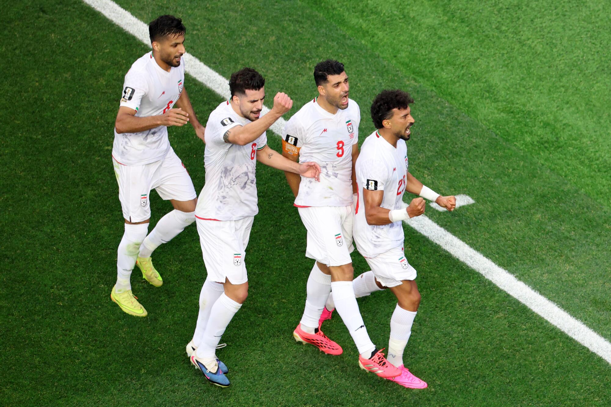 Iran defender Ramin Rezaeian celebrates with teammates after scoring during a World Cup match against New Zealand.