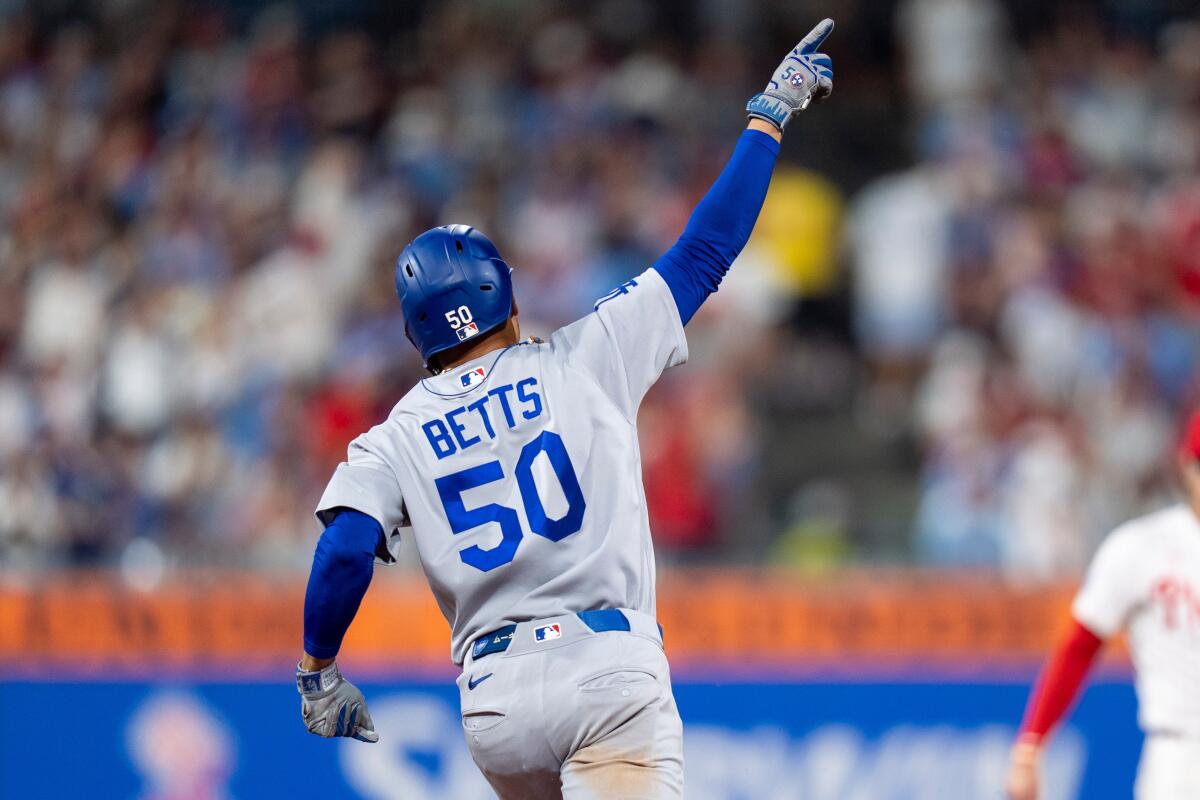 Mookie Betts celebrates after hitting a home run for the Dodgers in the seventh inning Monday.