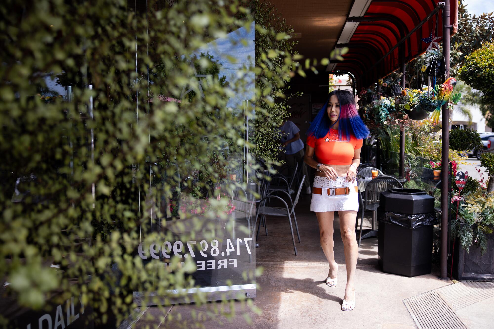 Owner, Lynda Trang Dai, walks into her banh mi shop Lynda Sandwich in Westminster, Calif.