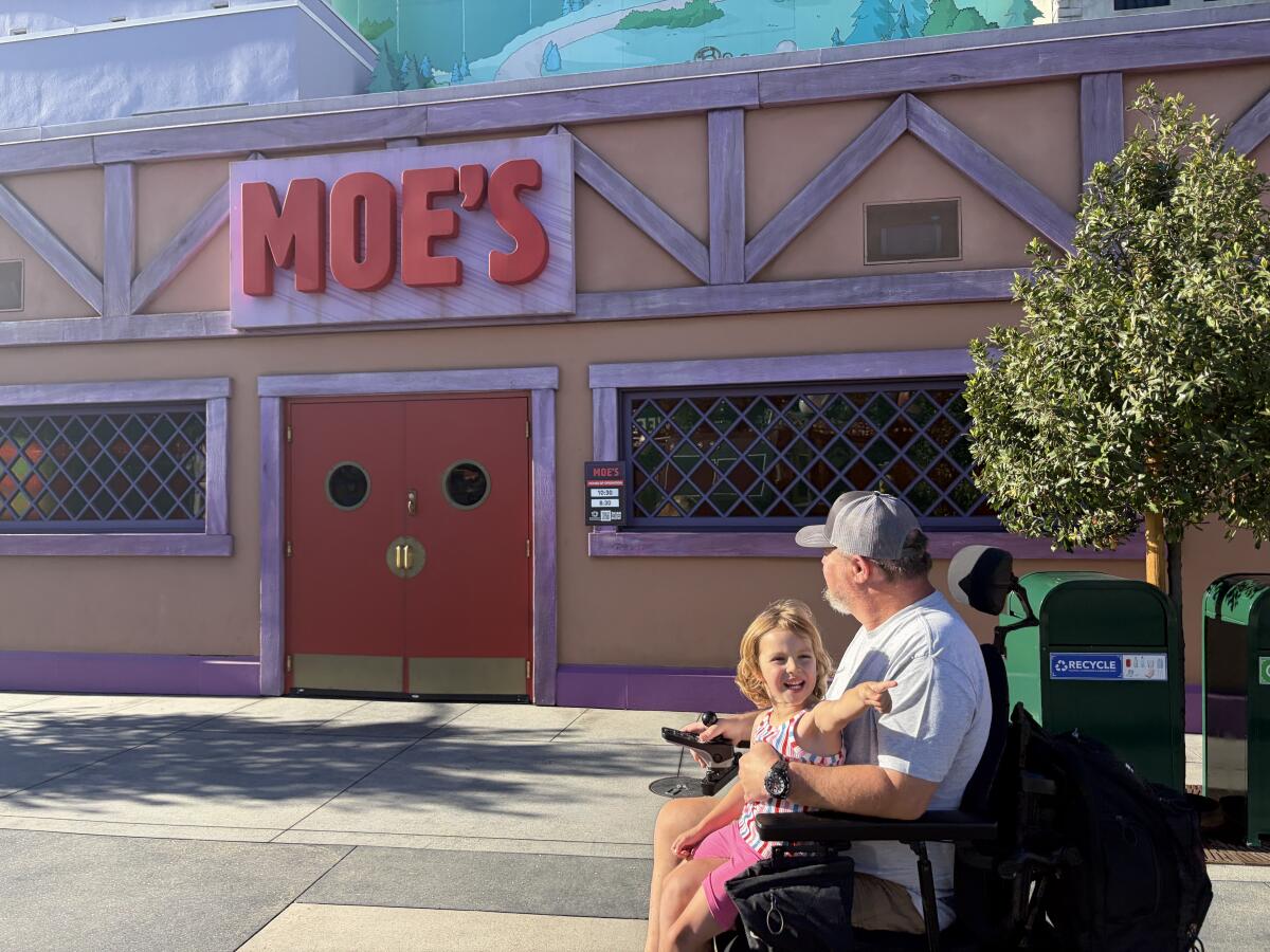 The author's father and daughter near Moe's Tavern at Universal Studios Hollywood.