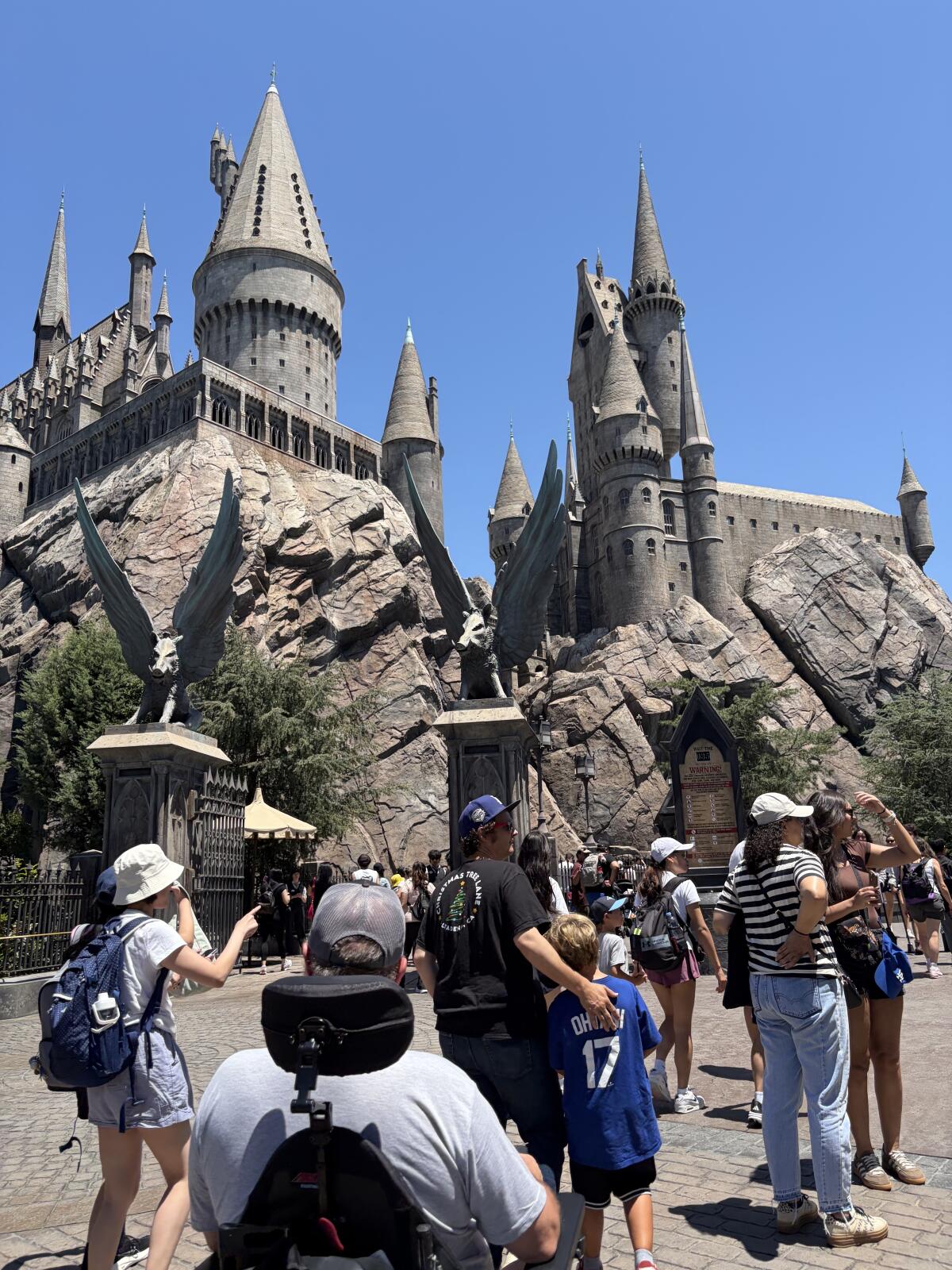 The author's father, in wheelchair, outside Hogwarts Castle at Universal Studios Hollywood.