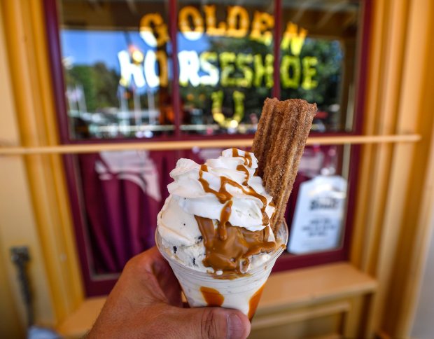 Disney Halloween Food: Cookie dough ice cream and cookie butter sauce, garnished with a cinnamon sugar-dusted churro and topped with cajeta and whipped cream available at Golden Horseshoe at Disneyland in Anaheim, CA, on Wednesday, Sep 12, 2018. (Photo by Jeff Gritchen, Orange County Register/SCNG)