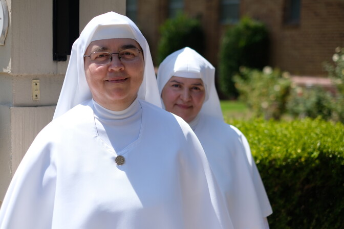 Two nuns in white habits.