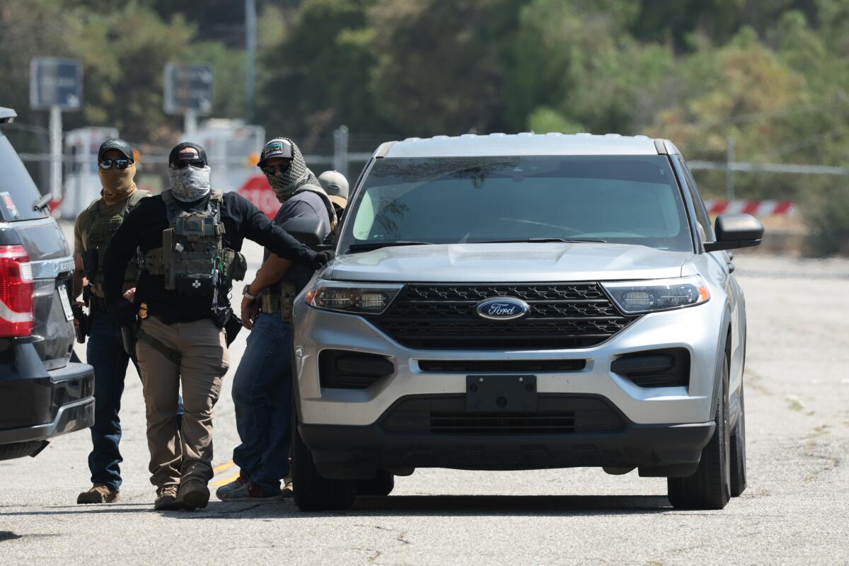 Federal agents stage outside Gate E of Dodger Stadium