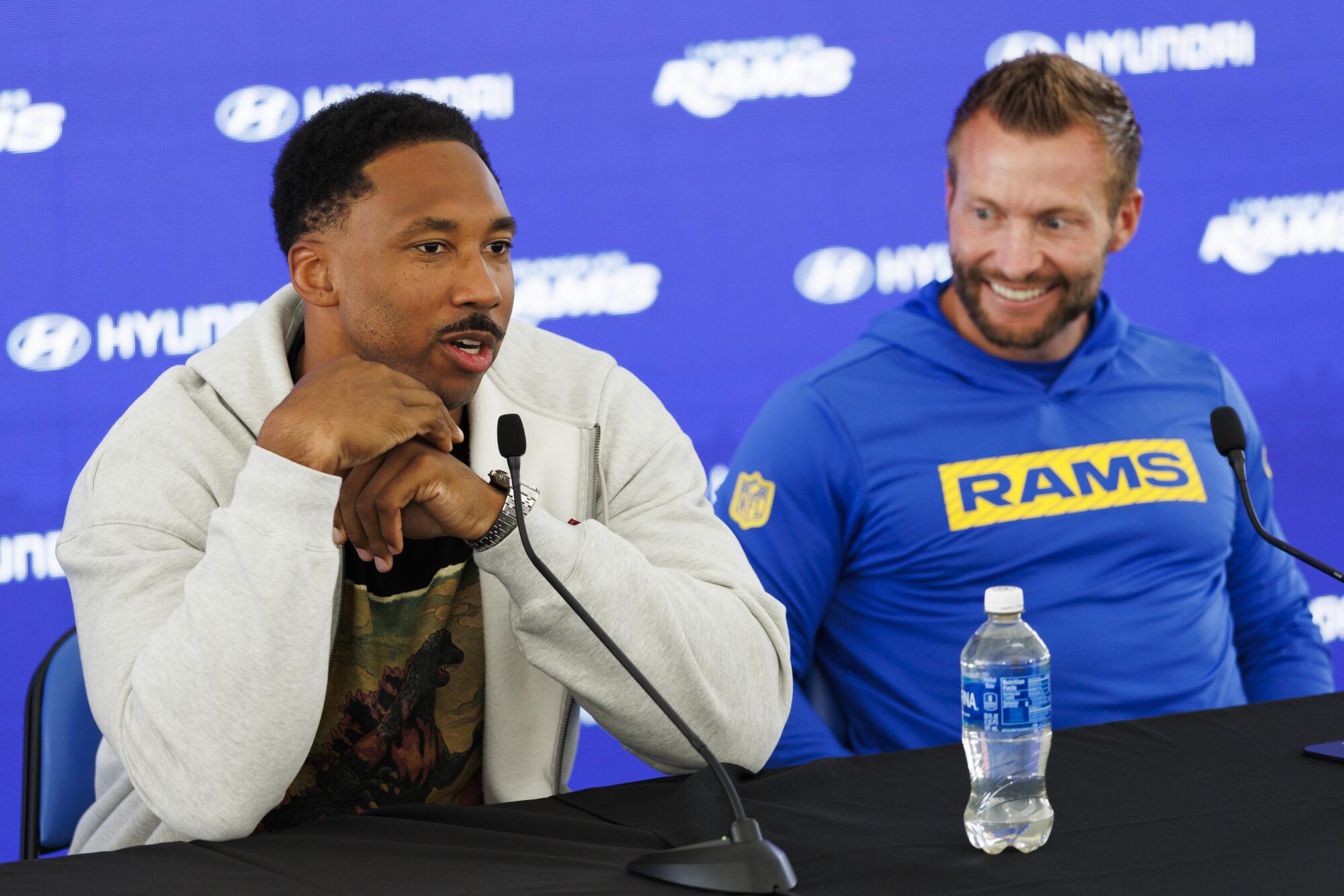 Rams defensive end Myles Garrett, left, speaks during a news conference while sitting next to coach Sean McVay on June 2.