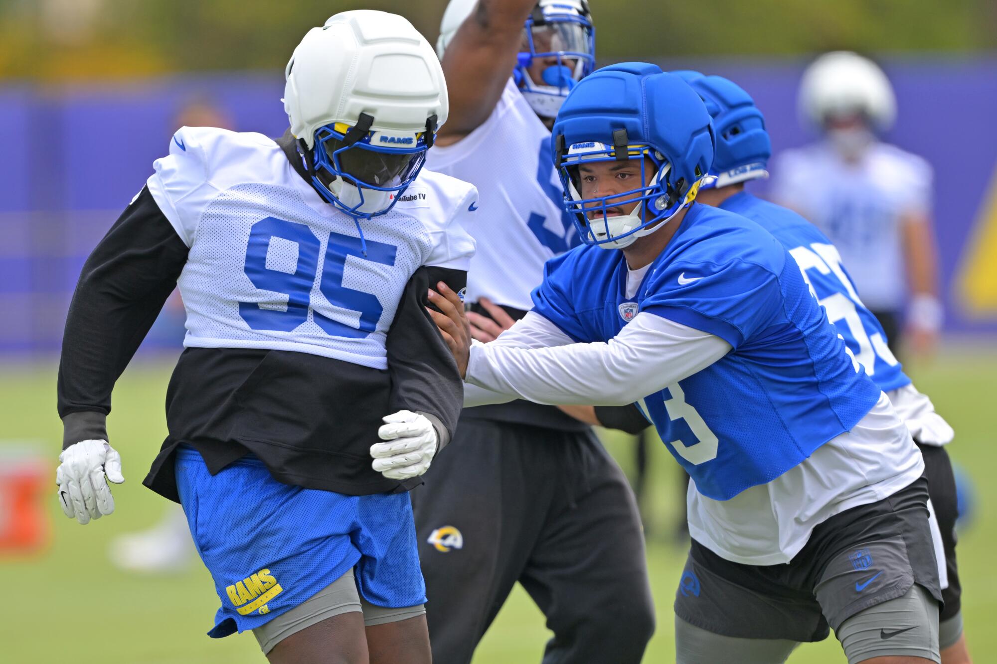 Rams guard Steve Avila, right, blocks defensive tackle Poona Ford in practice in May.