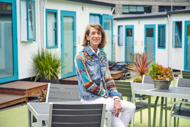 DignityMoves CEO Elizabeth Funk sits for a portrait in the community of tiny home shelters on Gough Street in San Francisco, CA on Friday, May 24, 2024. The homes, which started as a tent community, provide transitional housing for clients on their way to permanent living situations. (Don Feria for Bay Area News Group)