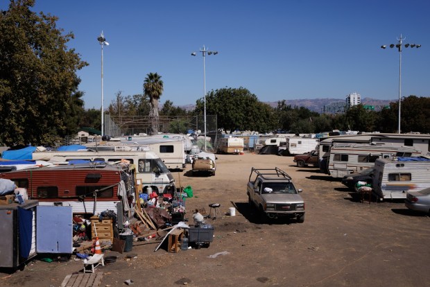 RVs and tents occupy Columbus Park along Asbury Street on Sept. 30, 2022, in San Jose, Calif. People who were displaced from an encampment by the Norman Y. Mineta San Jose International Airport have formed this new encampment across the street. (Dai Sugano/Bay Area News Group)