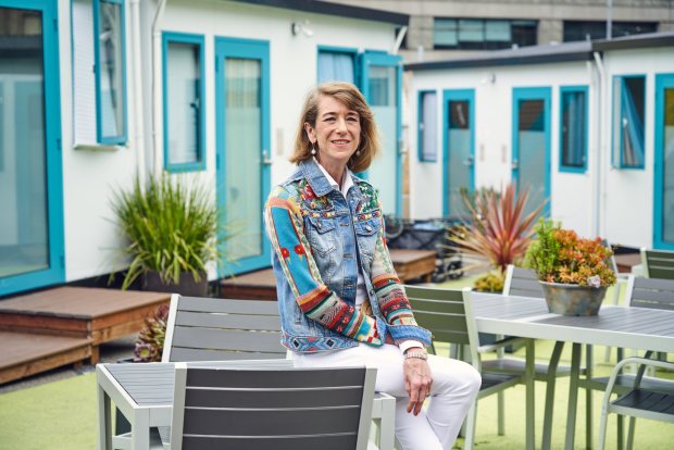 DignityMoves CEO Elizabeth Funk sits for a portrait in the community of tiny home shelters on Gough Street in San Francisco, CA on Friday, May 24, 2024. The homes, which started as a tent community, provide transitional housing for clients on their way to permanent living situations. (Don Feria for Bay Area News Group)