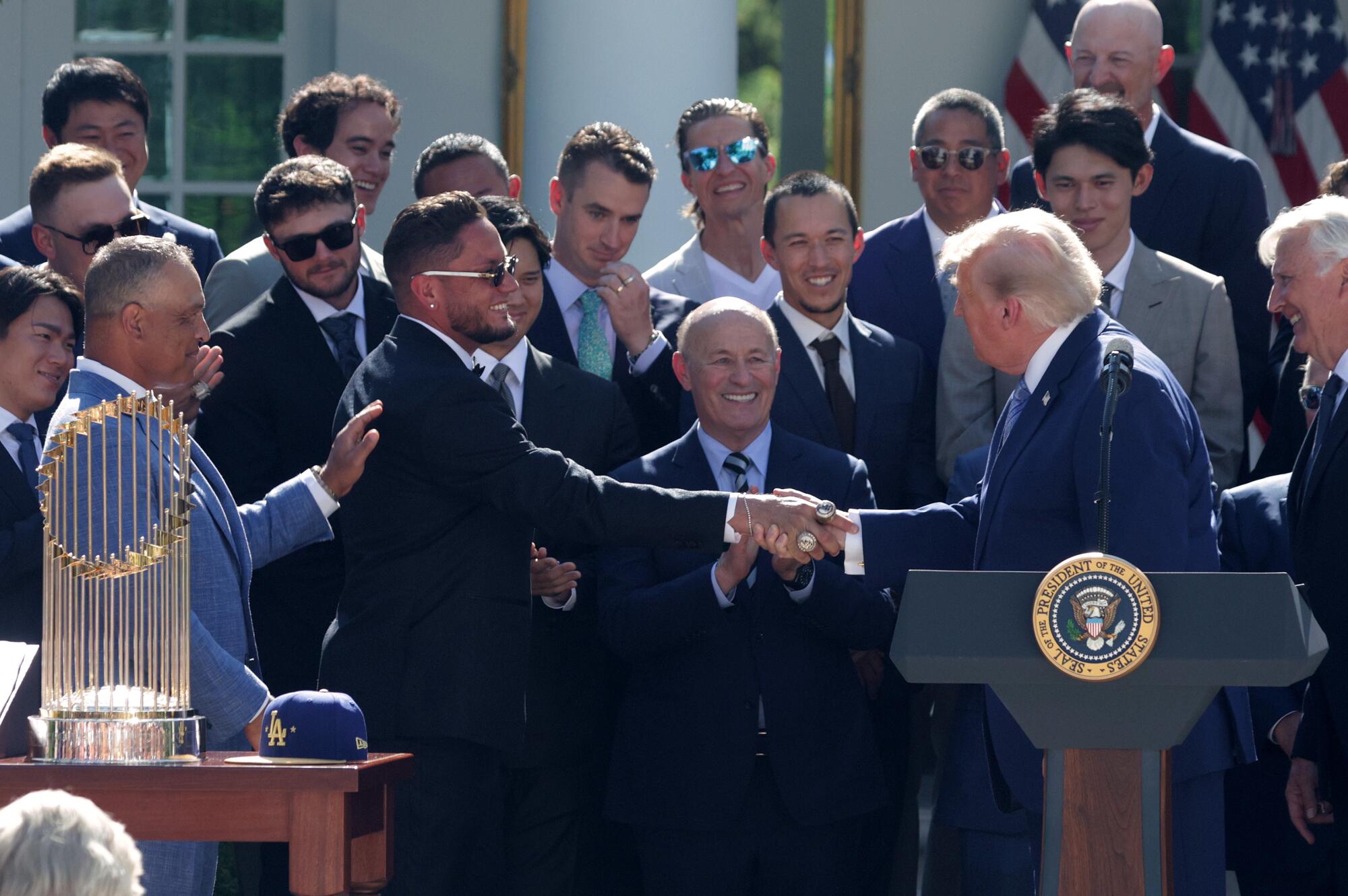 President Trump shakes hands with Miguel Rojas in the Rose Garden of the White House on Thursday.