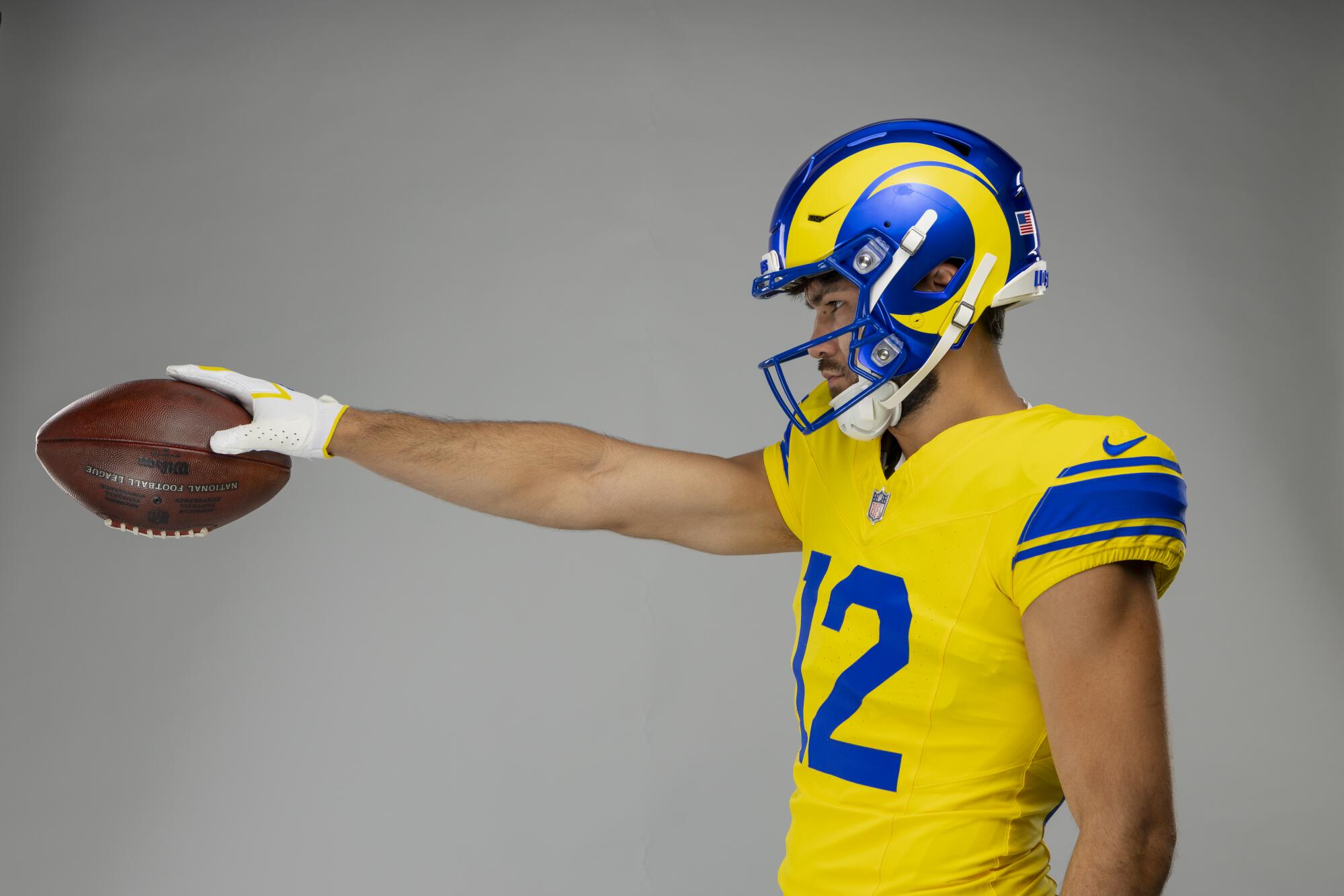 Rams wide receiver Puka Nacua shows off the team's new "Classic Sol" uniform.