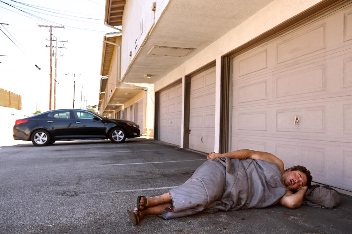 July 2023 photo of Andrew Truelove sleeping in a parking lot in Torrance.