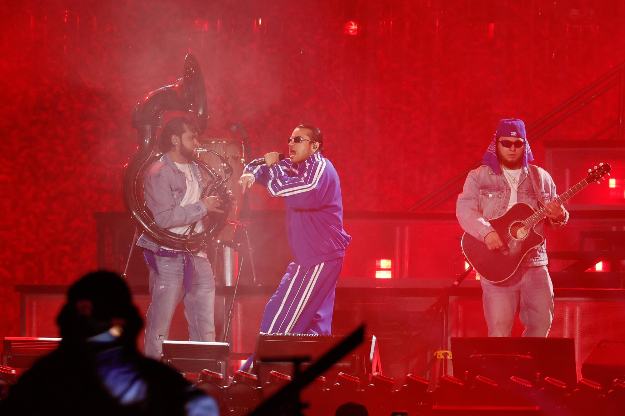  Jose "Pelon" Garcia, Jesus Ortiz Paz and Khrystian Ramos of Fuerza Regida perform at Dodger Stadium under red lights