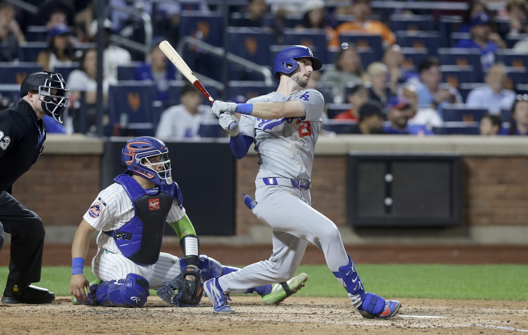 Kyle Tucker follows through on a two-run home run for the Dodgers in the eighth inning.