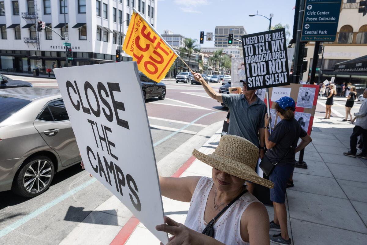 Heba Turner holds a protest sign. 