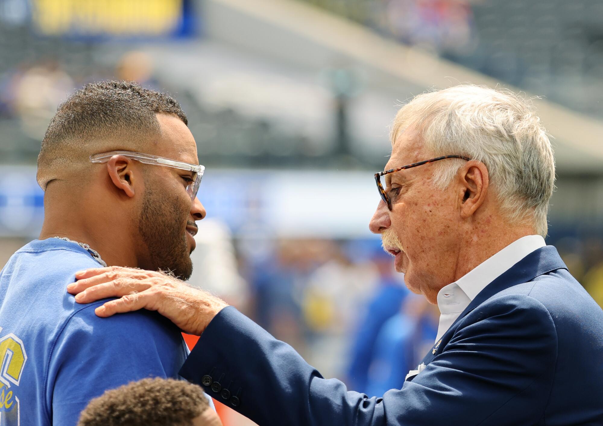 Former Rams defensive tackle Aaron Donald, left, greets Rams owner Stan Kroenke.