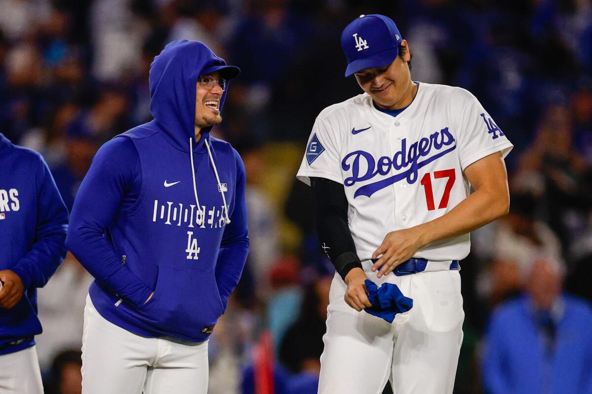 Dodgers teammates Kiké Hernández, left, and Shohei Ohtani laugh after a win over the Philadelphia Phillies.