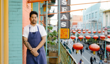 Brandon Jew, executive chef and owner of Mister Jiu's, stands on the balcony of the restaurant in San Francisco