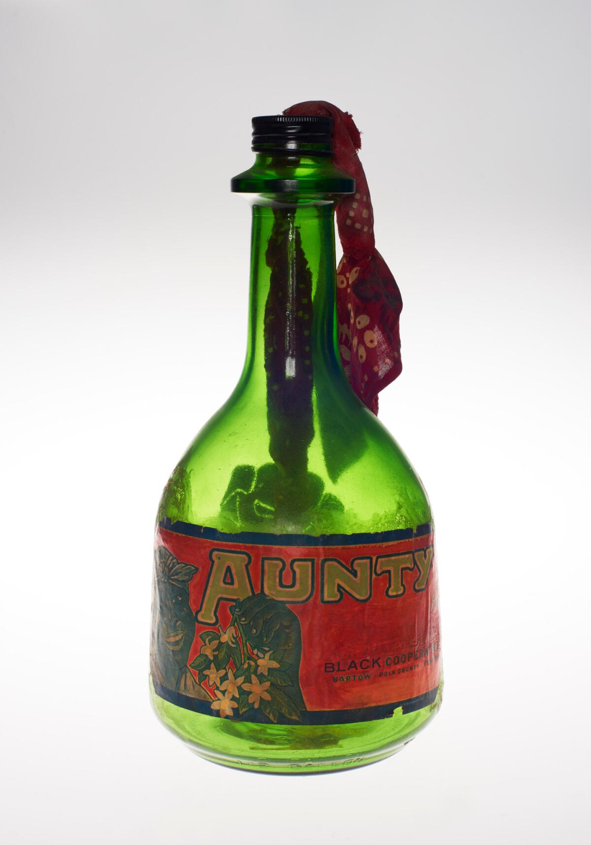 A vintage bottle of Aunt Jemima syrup is transformed into a sculpture resembling a Molotov cocktail.