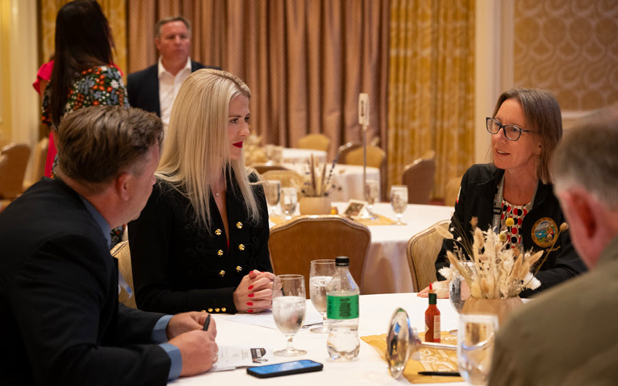 Senator Blakespear, Elizabeth Smart, and others seated at event table.