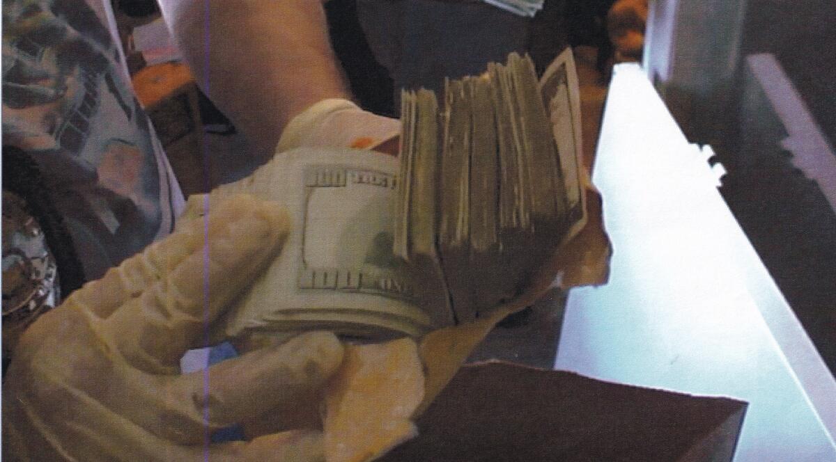 Police found stacks of cash in Hermilio Franco's safe after he was killed.