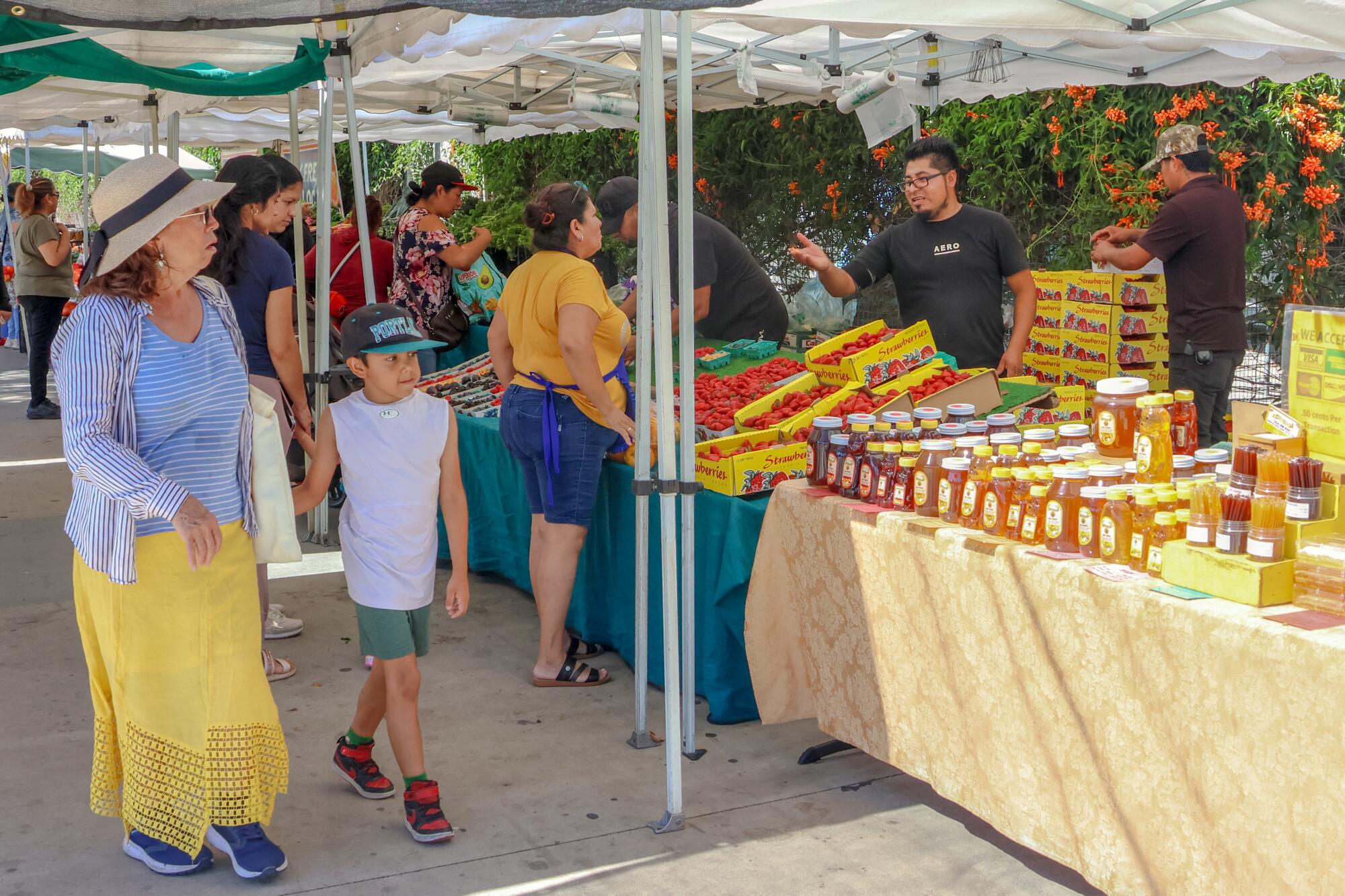 Shoppers browse the vendor stalls at the Central Avenue Farmers Market
