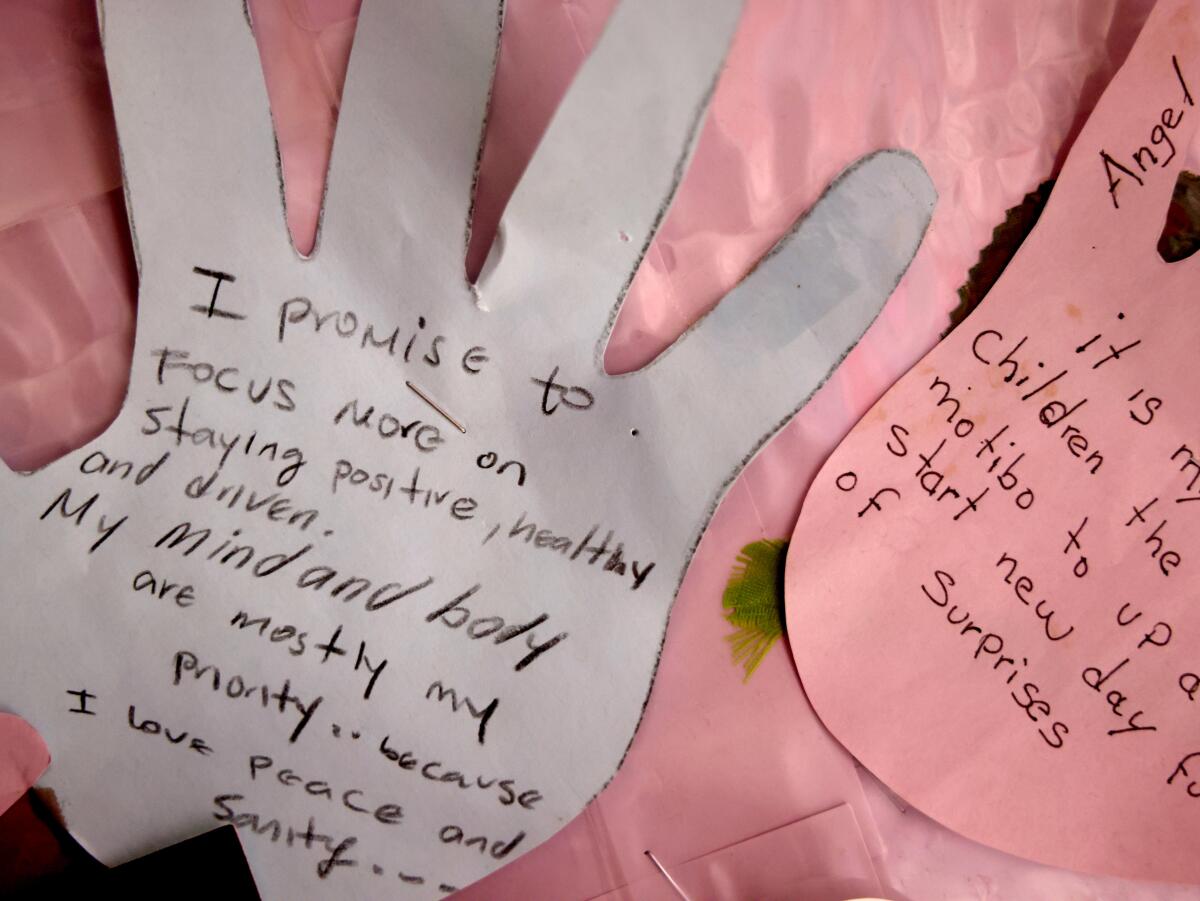 Art with positive messages, created by women, who are victims of domestic violence, hangs on the wall