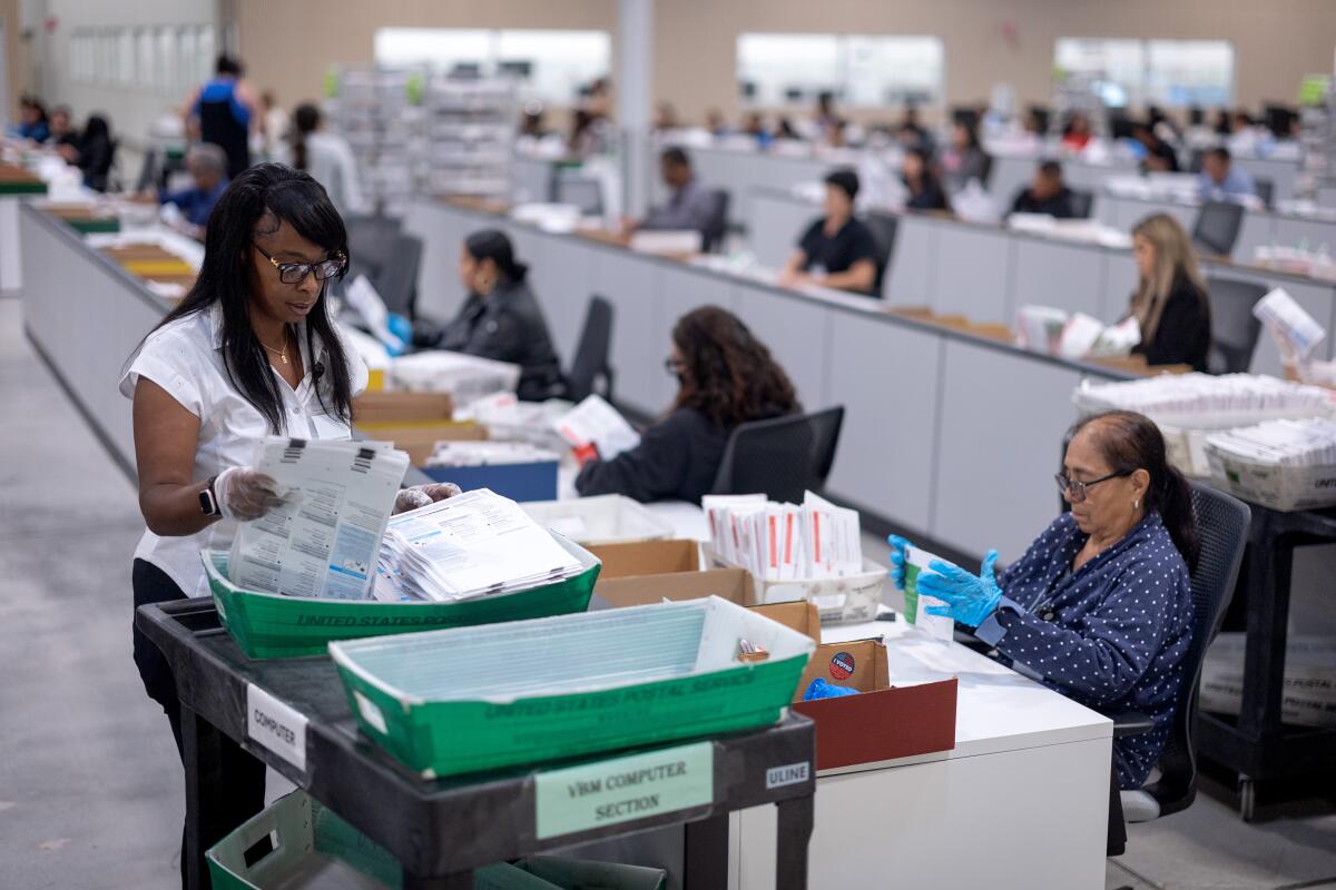 Workers organize and examine ballots at a Los Angeles County Ballot Processing Center 