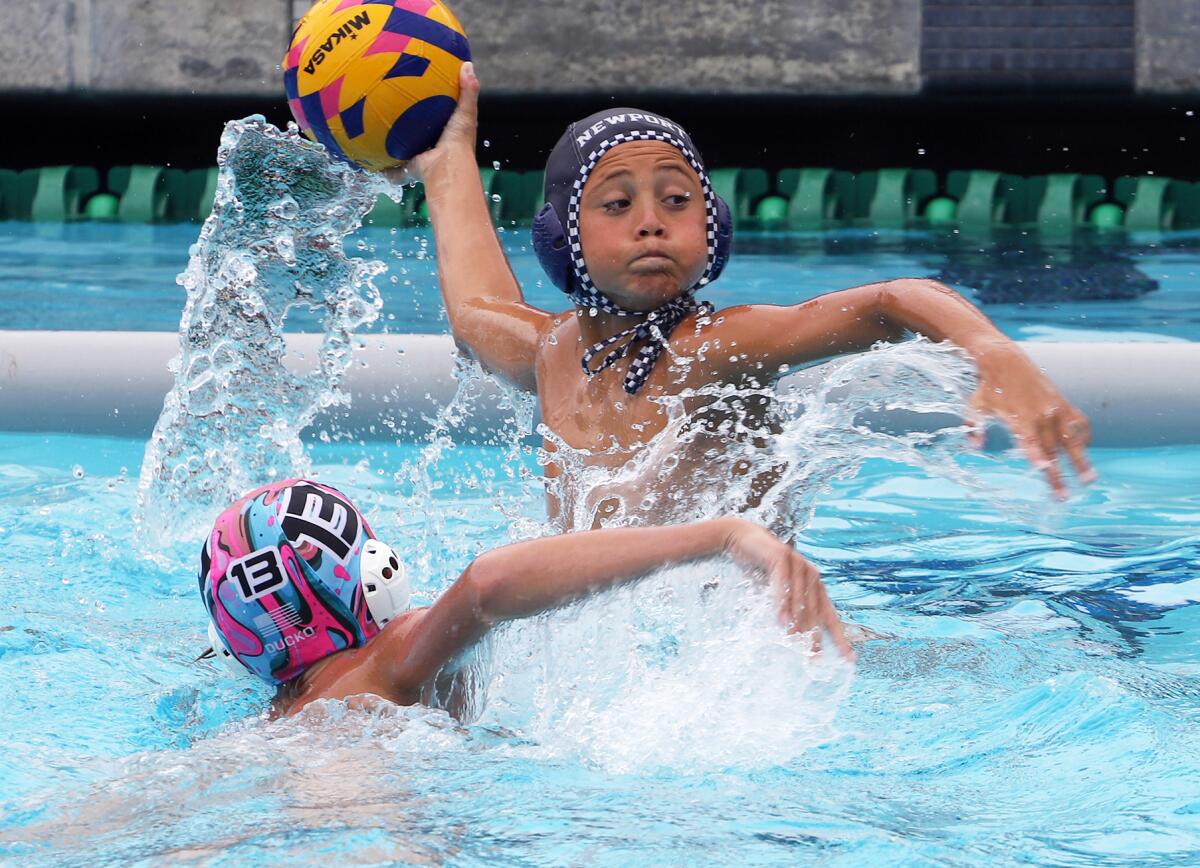 Newport Beach's Mick Wawrzynski (7) shoots and scores against 908 at the USA Water Polo Junior Olympics on Sunday.