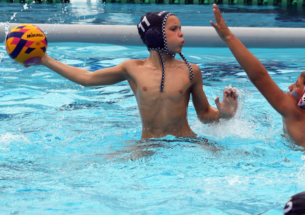 Newport Beach's John Gess (11) looks for an open player against 908 on Sunday.