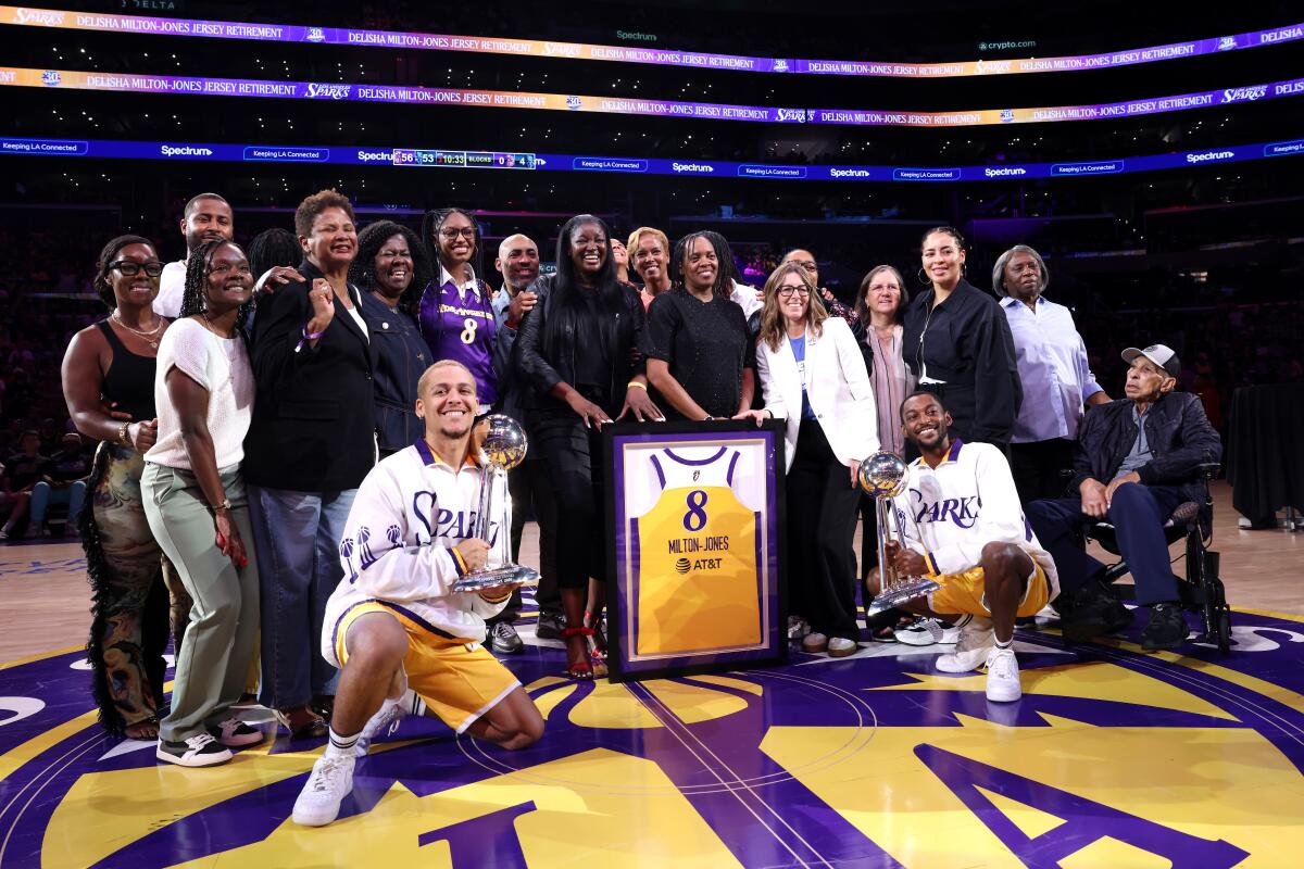 Former Sparks player DeLisha Milton-Jones poses with family and friends during her jersey retirement ceremony Tuesday.