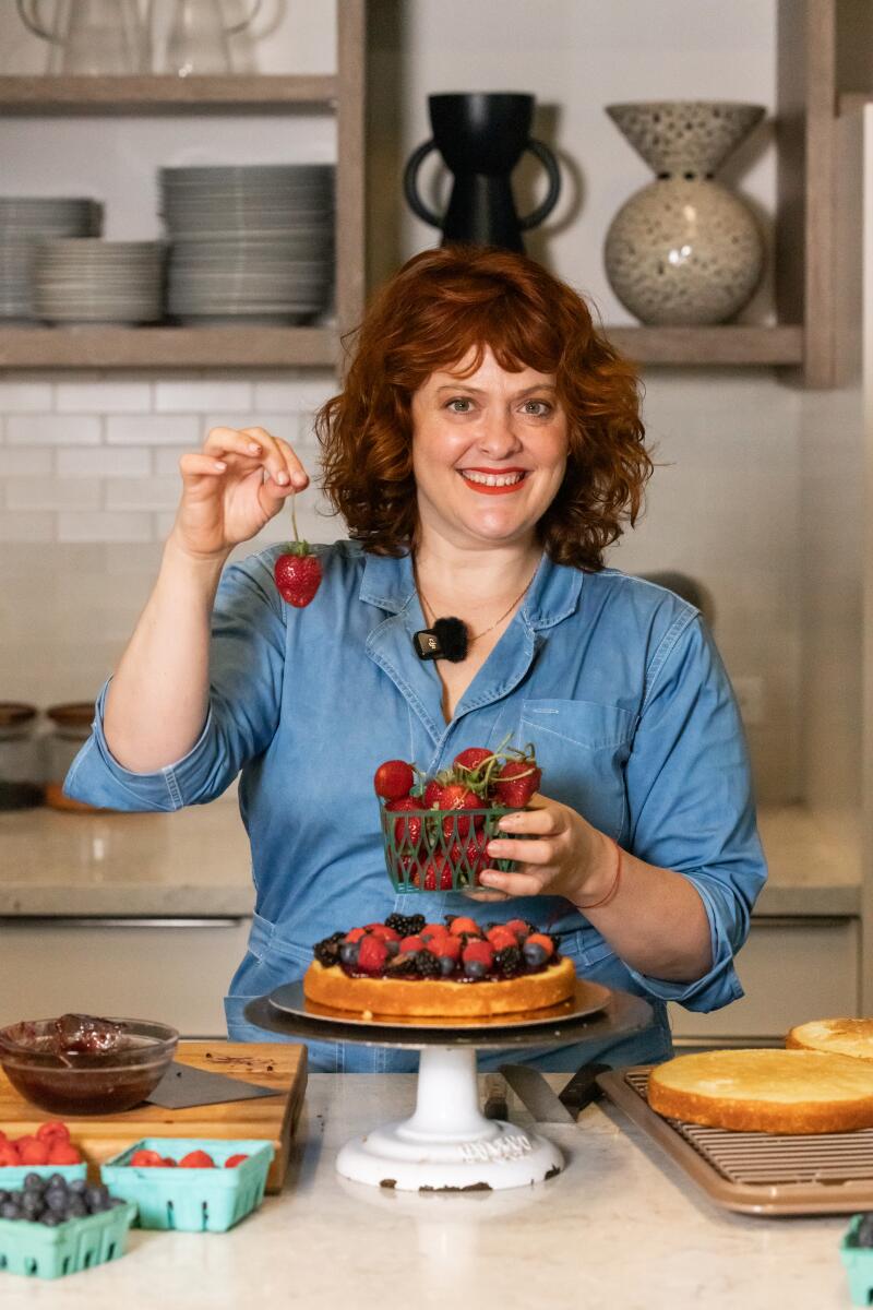 Rose Wilde decorating a berry cake in the L.A. Times Kitchen.
