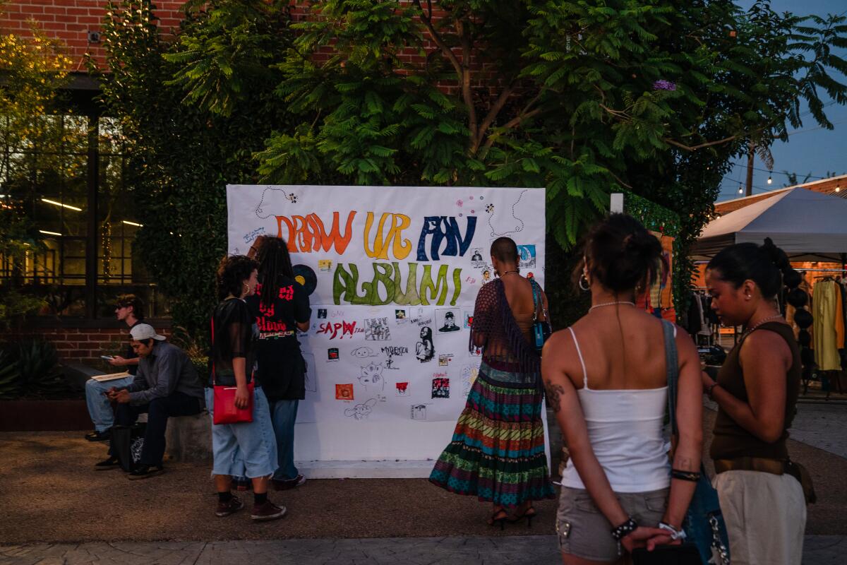 A poster at the Beehive Block Party reads "Draw Ur Fav Album."