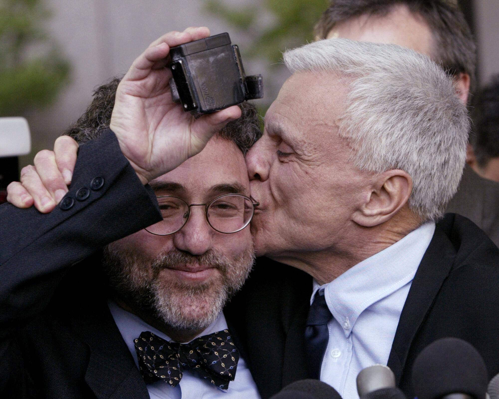 Robert Blake, right, kisses his attorney M. Gerald Schwartzbach.
