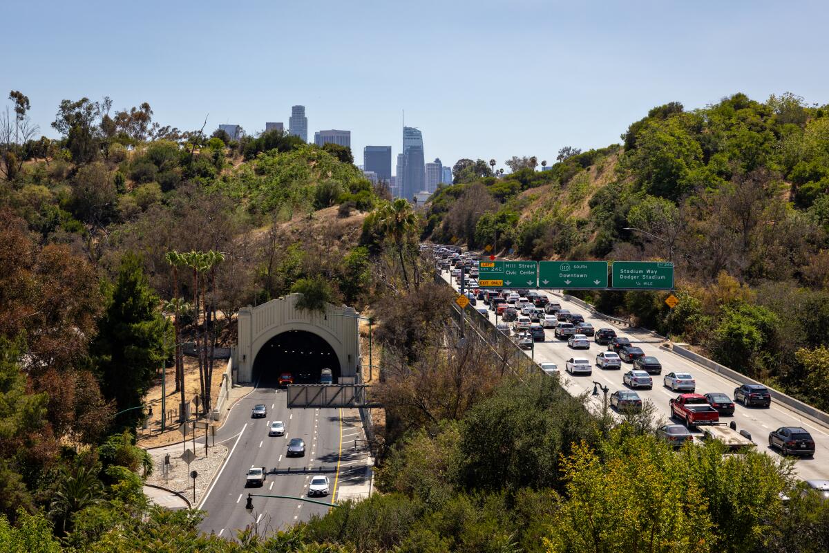 Traffic on the Arroyo Seco Parkway and 110 Freeway with downtown Los Angeles in the background.
