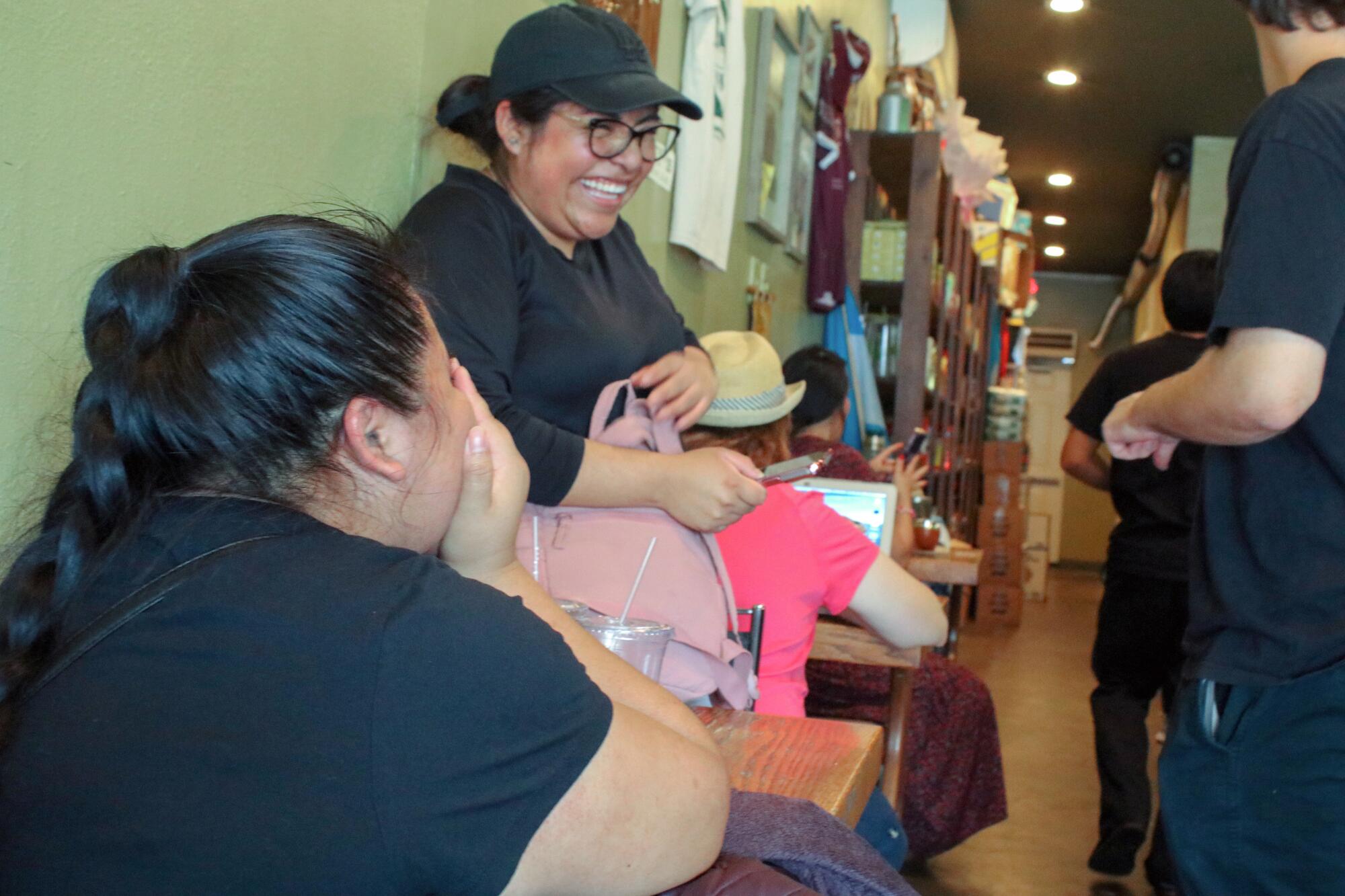 Itzel Celis laughs over mate with friends July 15 at the Northridge cafe Mate Conmigo.