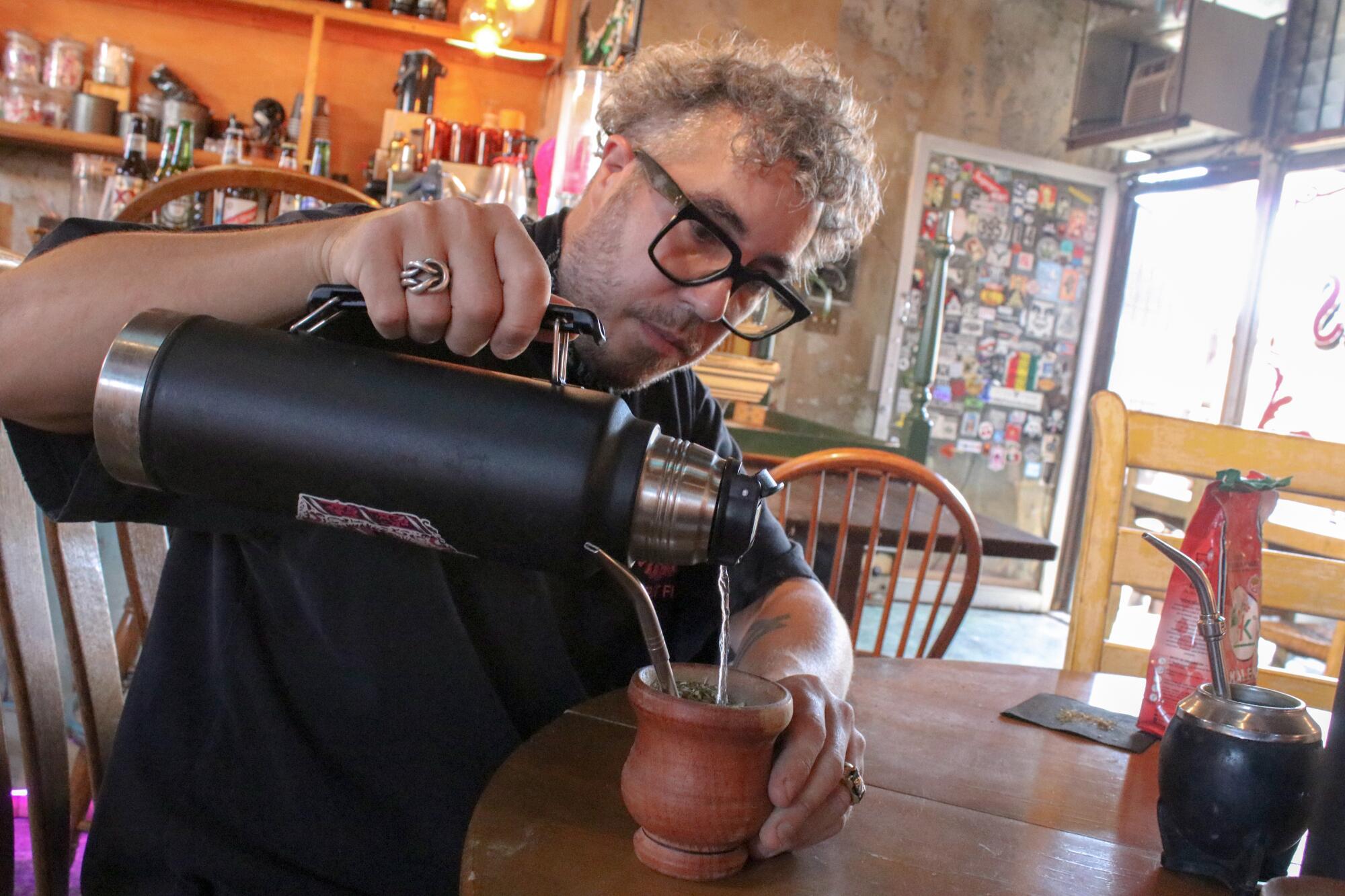 Federico Laboureau, co-owner of Fuegos LA, demonstrates the steps of making mate. 