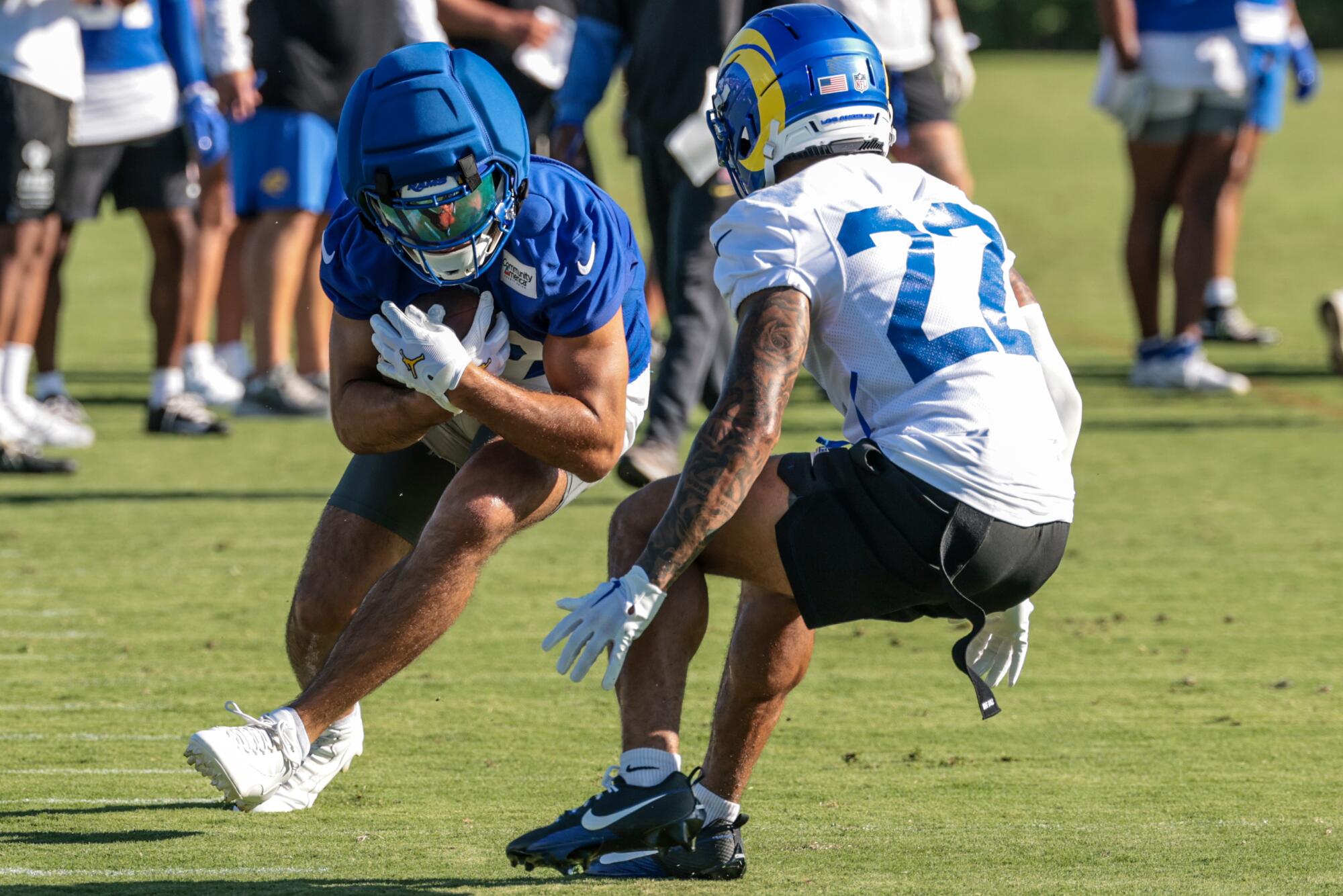 Rams receiver Puka Nacua tries to slip past defensive back Trent McDuffie during training camp at Loyola Marymount.