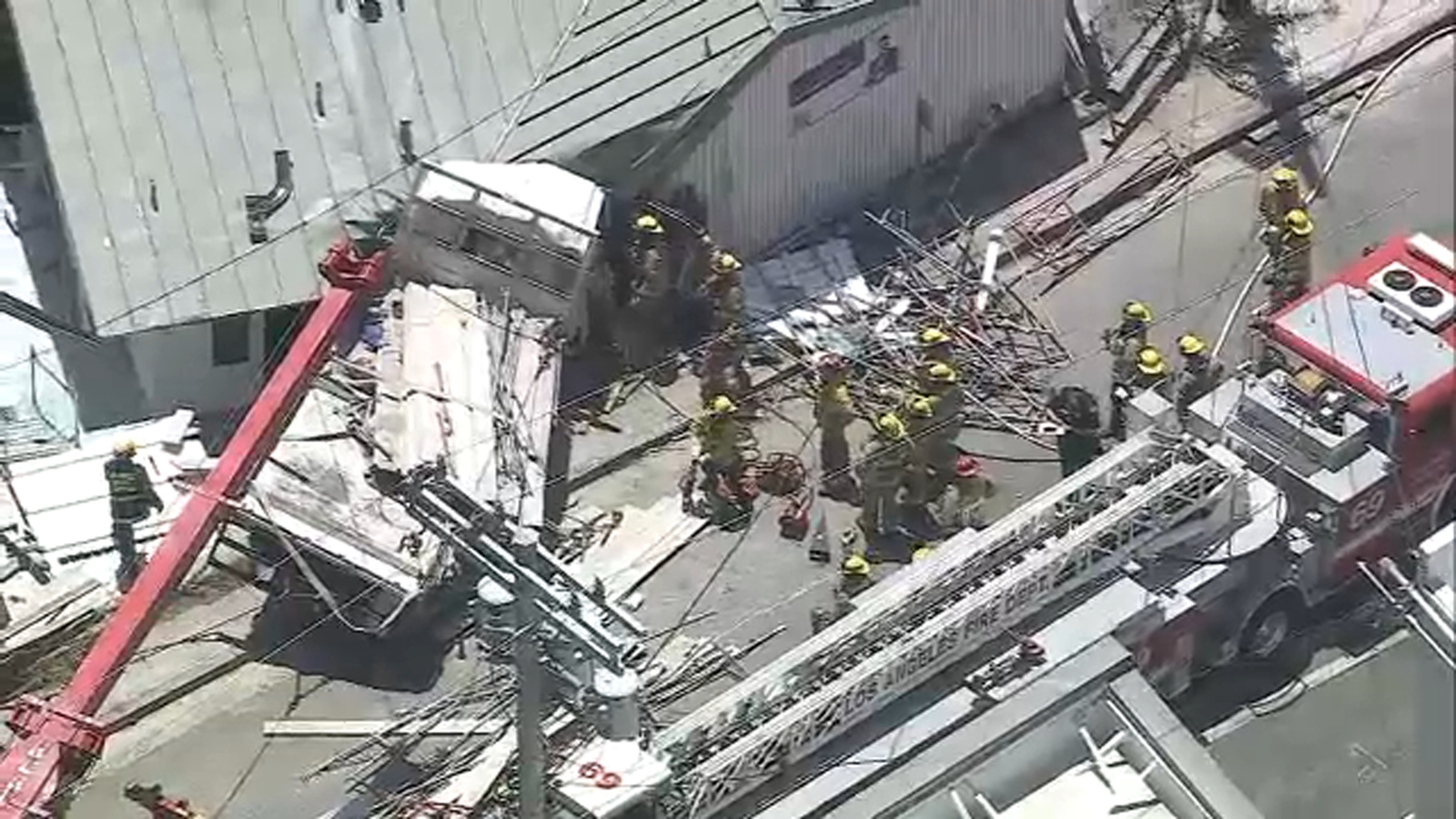 Firefighters rescue trapped driver after flatbed truck slams into building in Pacific Palisades