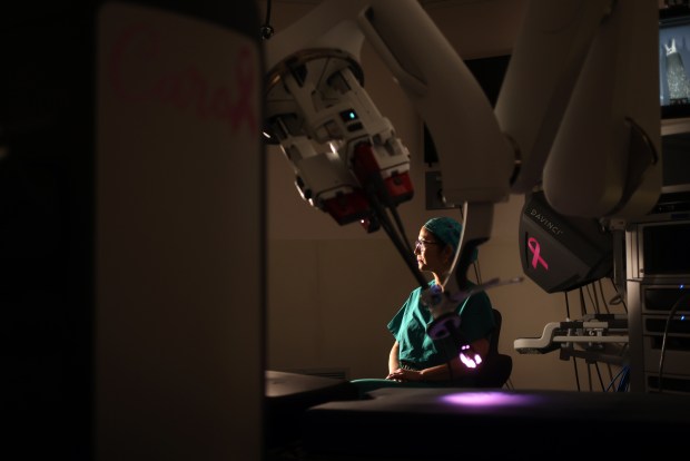 Dr. Rita Kwan-Feinberg with a da Vinci signal port surgical system by Intuitive in an operating room at Sutter Health's Alta Bates Summit Medical Center on Thursday, July 23, 2026, in Oakland, Calif. (Aric Crabb/Bay Area News Group)